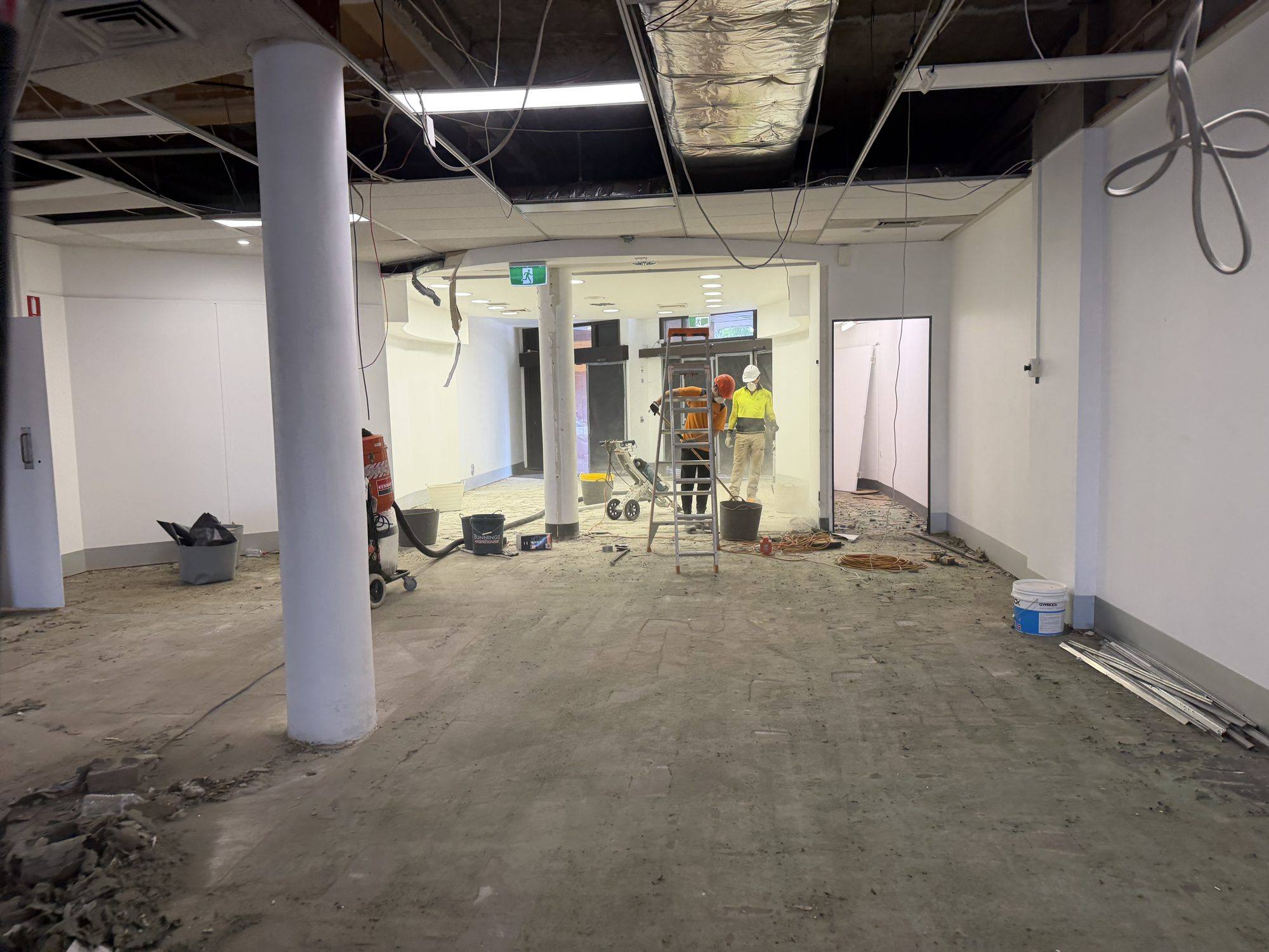 HazWreck crew stripping asbestos-containing linings inside a commercial tenancy