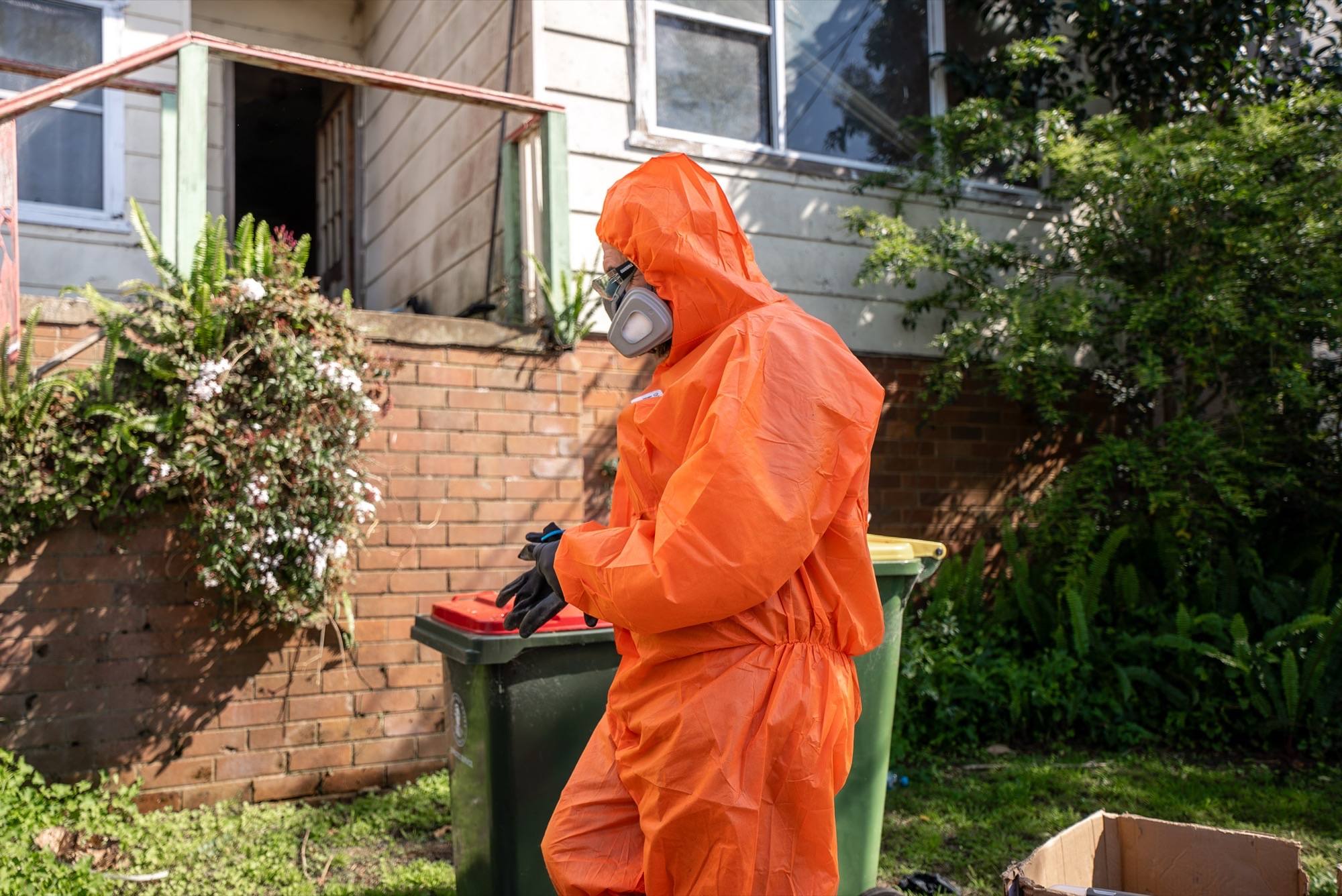 HazWreck crew member carrying contents out to the bins during a Sydney clean-out