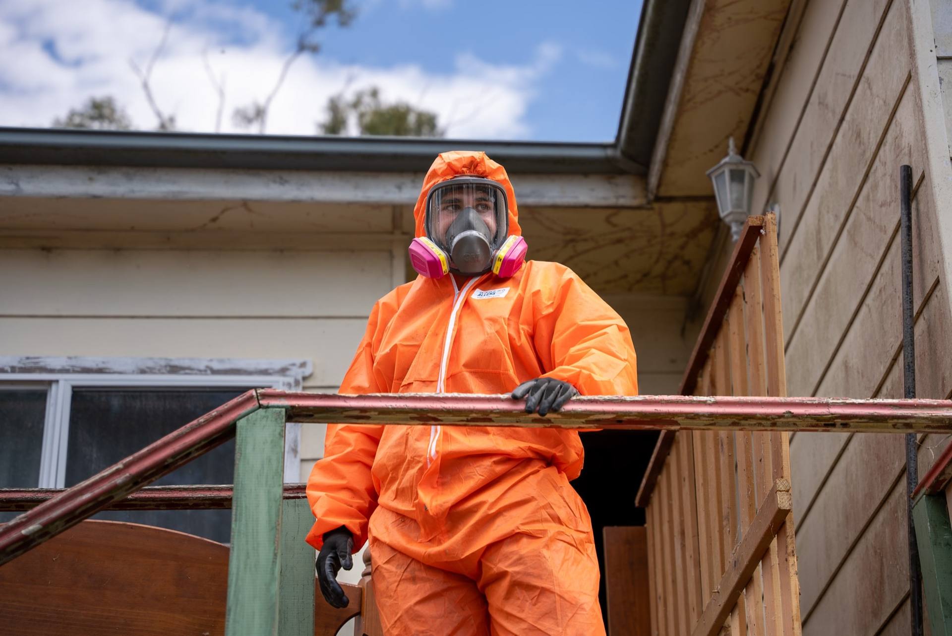 HazWreck removalist in full PPE and full-face respirator on a residential asbestos removal in Sydney