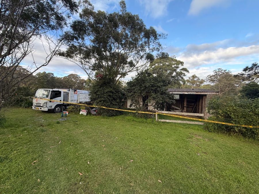 HazWreck truck on site with asbestos hazard tape in place around a fibro shed removal in Sydney