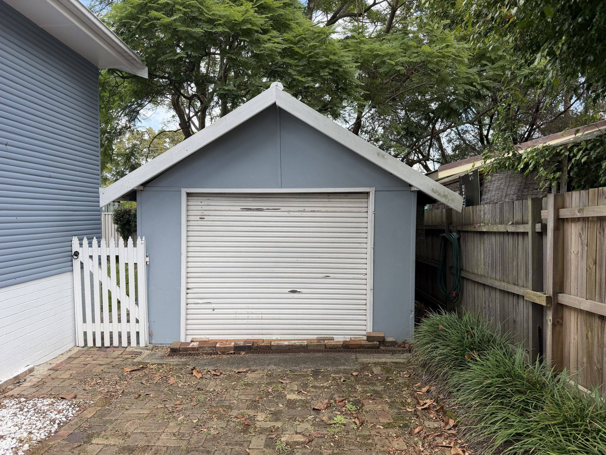 Blue fibro garage with its Super Six asbestos roof in Northmead before removal