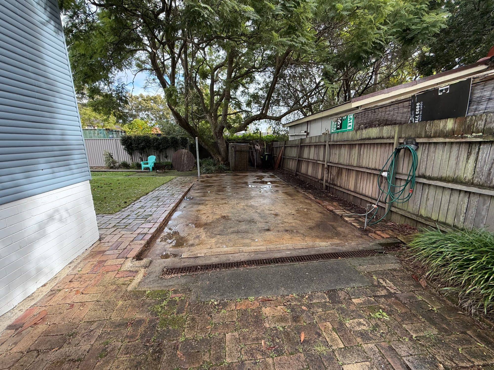 A garage slab washed down and handed back clean after licensed asbestos removal