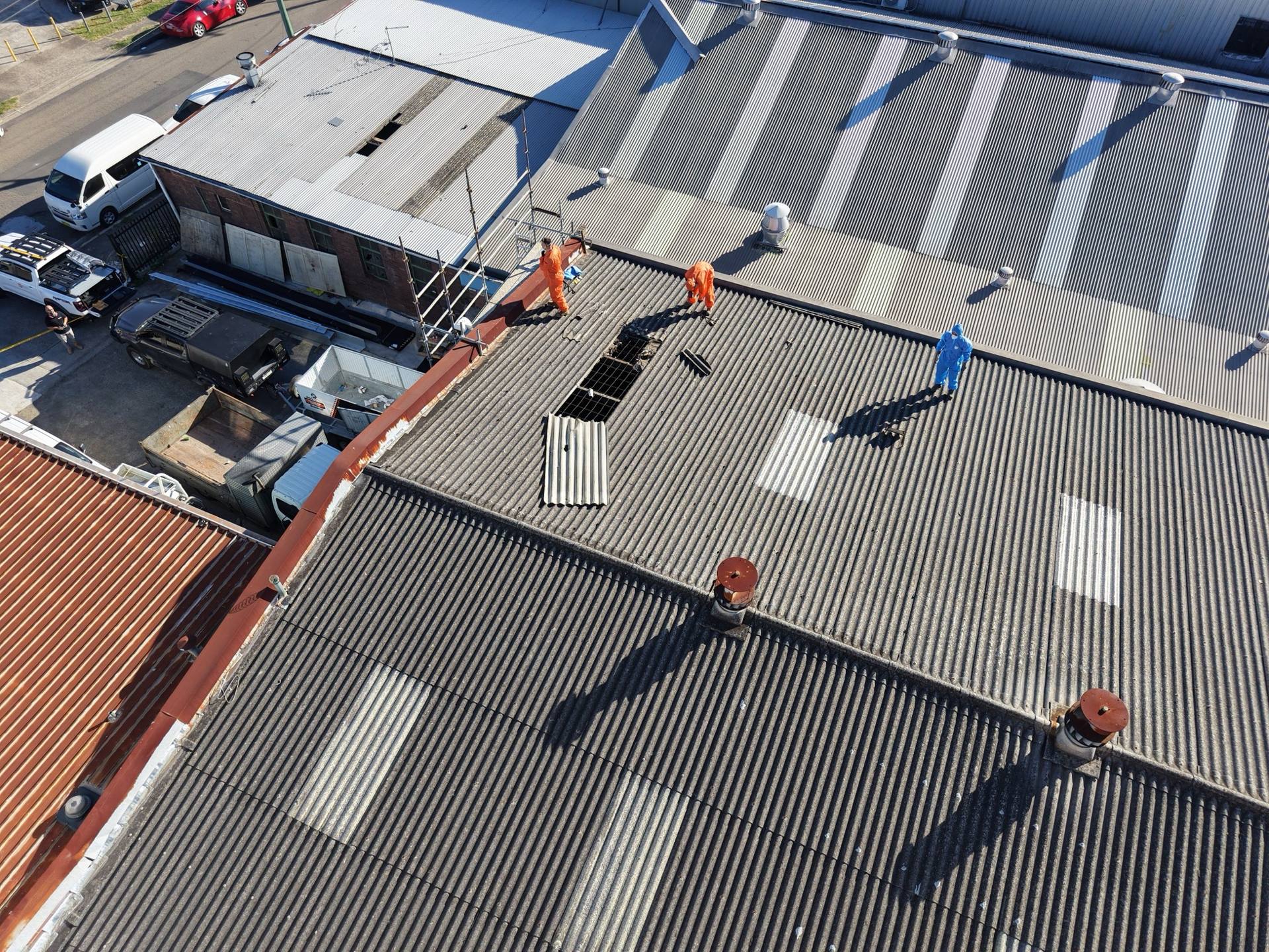 Licensed HazWreck crew in PPE removing a corrugated asbestos cement roof on a Sydney property