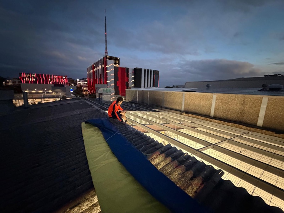 Asbestos roof tarped down and made weather-tight at dusk on the Artarmon job