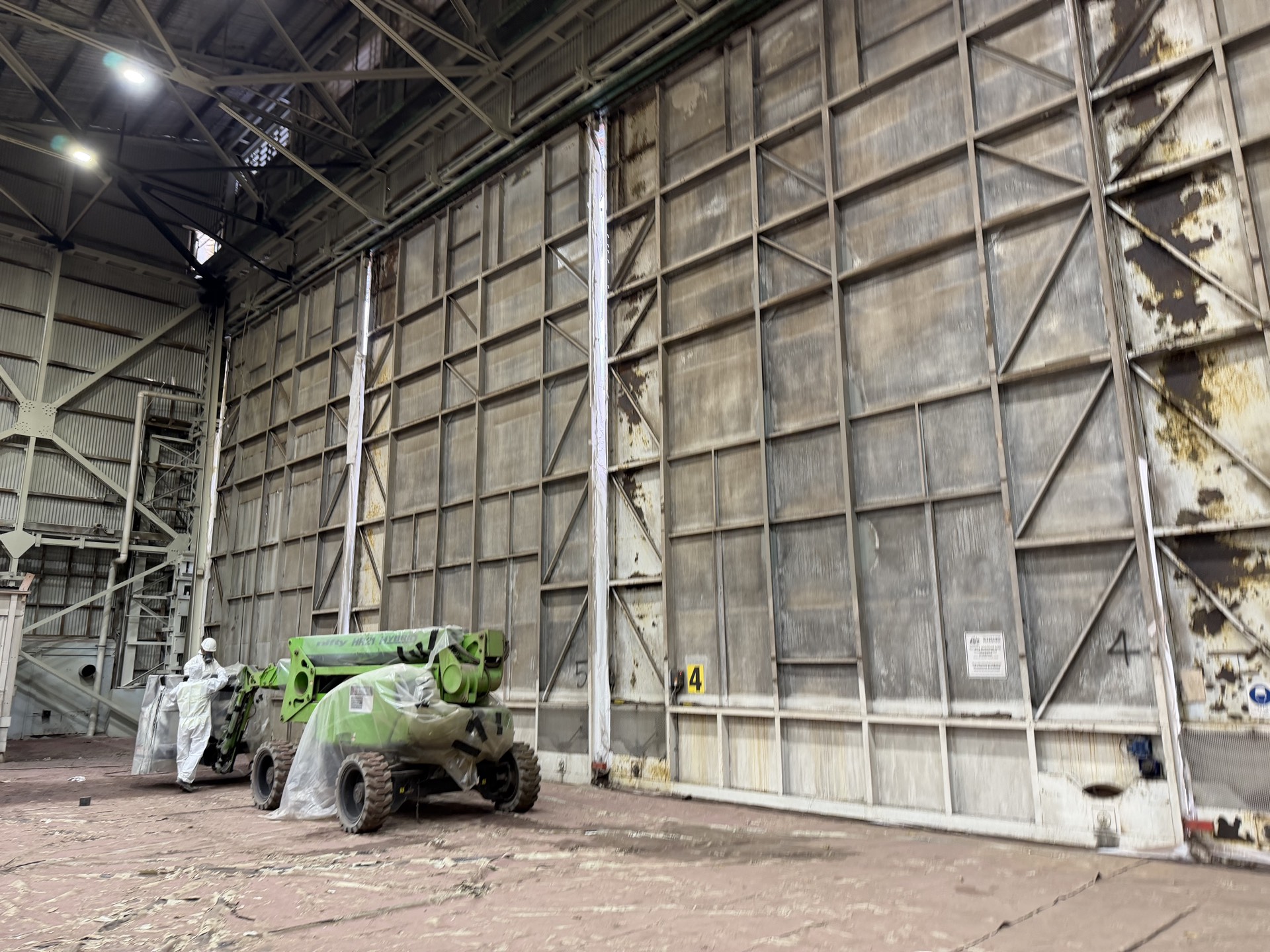 Aircraft hangar at Sydney Airport with large structural hangar doors being prepared for removal